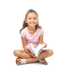 Sticker - Cute little girl reading book on white background