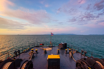 Wall Mural - Prow of big passenger boat in the ocean amidst the beautiful nature of the evening sea and the colorful sky during sunset while cruising to Koh Samui Island in Surat Thani, Thailand