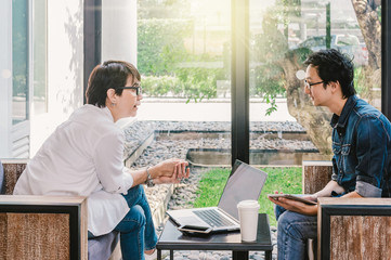 Couple of Business people with casual suit talking with happy action in the modern Office or coffee shop,business group concept