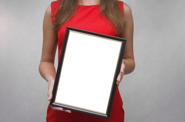 Wall Mural - Grateful letter. Gratitude concept. Accolade. Thank letter. Special offer. Young woman in red dress holding in hands empty blank photo frame. Appreciation document.  The winner.