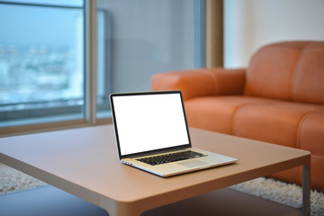 Poster - Laptop on table in modern living room with blank screen