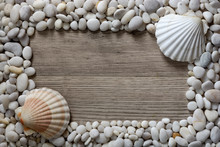 Frame Of White Mramor Stones And Seashells On Wooden Background