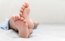 Little Girl's Feet Who Sleeps In Her Bed