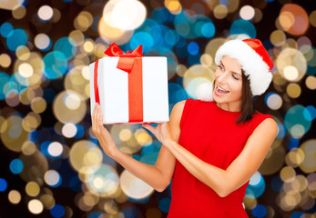 Sticker - smiling woman in santa hat with christmas gift