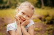© svetabezu - Adorable smiling little blonde girl with braided hair. Cute child having fun on a sunny summer day outdoor.