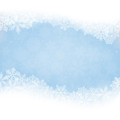 winter background. borders made of fluffy snowflakes with space for text on soft blue background wit