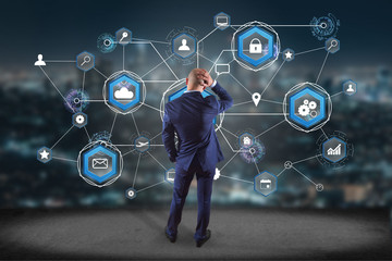 Sticker - Businessman in front of a wall with an International business network connection displayed on a futuristic interface with technology icon and sphere globe - Worldwide business concept