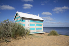 Beautiful Beach Hut On Melbourne's Brighton Beach With A Summer Blue Sky And Ocean Background