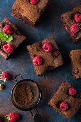 Sticker - raspberry brownies served  with fresh berries on blue background