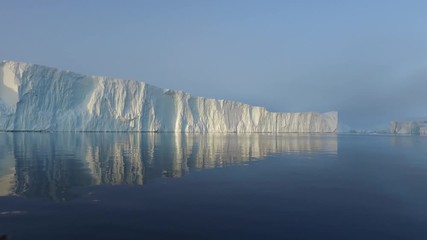 arctic icebergs greenland in the arctic sea. you can easily see that iceberg is over the water surfa