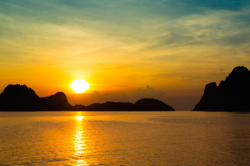 Wall Mural - Bright colors at dawn on the beach at sunrise in the Gulf of Thailand.