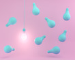 Hanging blue light bulbs with glowing one different idea on pastel pink background. minimal concept. top view.