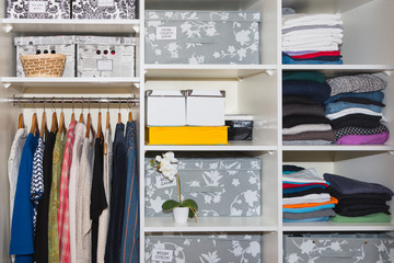  A well-organized closet. All things in their places, in boxes. Capsule wardrobe. Storage system.