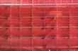 scaffolding on a building construction site covered with red safety netting