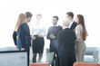 © ASDF - successful business team discussing documents and ideas standing near desktop