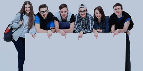 Sticker - Full length portrait of confident college students displaying blank billboard against white background