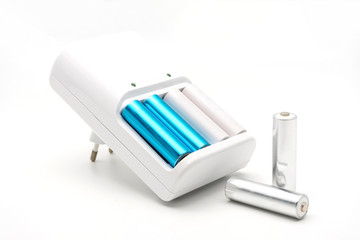 AA batteries rechargeable in accumulator charger, isolated on a white background