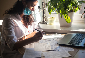 A female doctor is studying a patient's diagnosis