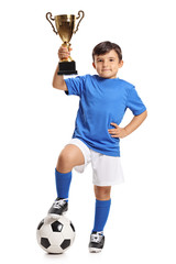 Wall Mural - Small boy in blue jersey with football and gold trophy