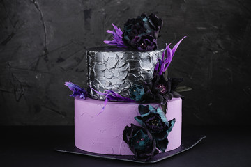 Wall Mural - Artwork wedding cake with fake flowers on black background