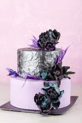 Wall Mural - Tiered wedding cake with black fake flowers