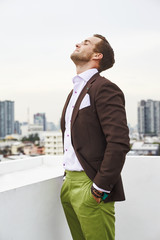 Wall Mural - Portrait caucasian hipster stunna guy in stylish suit with brown top