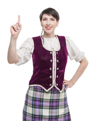 Wall Mural - Woman in traditional Scottish costume showing on something