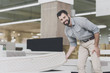 © VadimGuzhva - A man inspects a mattress in a mattress store. He lifted one of them
