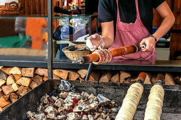 Manufacturer trdelnik on the streets of Prague. Out-of-focus.