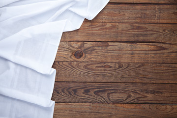 Wall Mural - Old vintage wooden table with white tablecloth. Top view mockup.