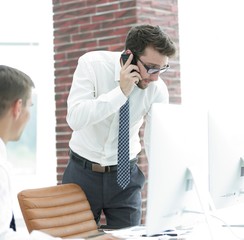 angry businessman talking on smartphone