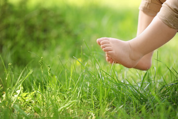 Little child and green grass in park