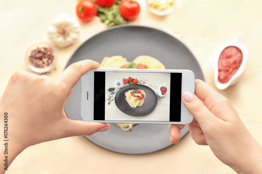 Woman photographing tasty dish, closeup