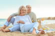© Africa Studio - Happy senior couple having picnic on sea beach