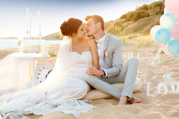 Wall Mural - Happy wedding couple on beach