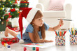 © Africa Studio - Cute girl drawing picture for Christmas on floor
