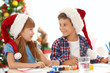 © Africa Studio - Cute children painting pictures for Christmas at table