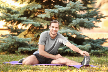 Wall Mural - Handsome young man training outdoors