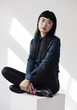 © W2 Photography/Stocksy - Portrait of a cool young fashionable woman on a white cube