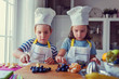 Kid chefs in the kitchen - preparing a healthy fruit snack