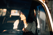 Young Woman Sitting In An Old Car