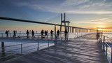 Photographers shooting sunrise at Vasco da Gama bridge in Lisbon