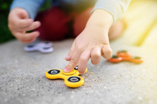 Close-up Photo Of Preschooler Boy Holding Rotating Fidget Spinners