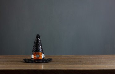 Fototapete - Happy Halloween decorations festival concept background.The hat of witch on modern rustic brown wooden at table home office.free space for creative design text and word.