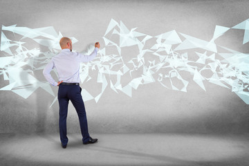 Poster - businessman in front of a wall with abstract triangle displayed on a futuristic interface with line 