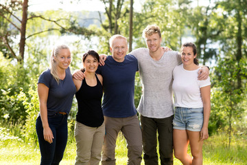 Confident Friends Standing Arms Around In Forest