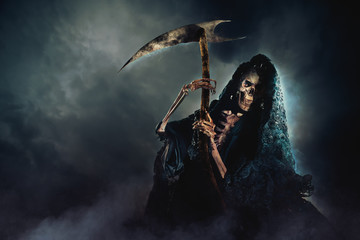 Wall Mural - grim reaper with scythe on a smoky background / high contrast image