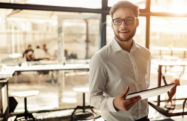 Wall Mural - Businessman holding mobile device in cafe