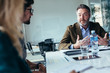 © Jacob Lund - Businessman explaining new business ideas to peers