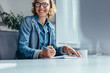 © Jacob Lund - Smiling businesswoman working in office